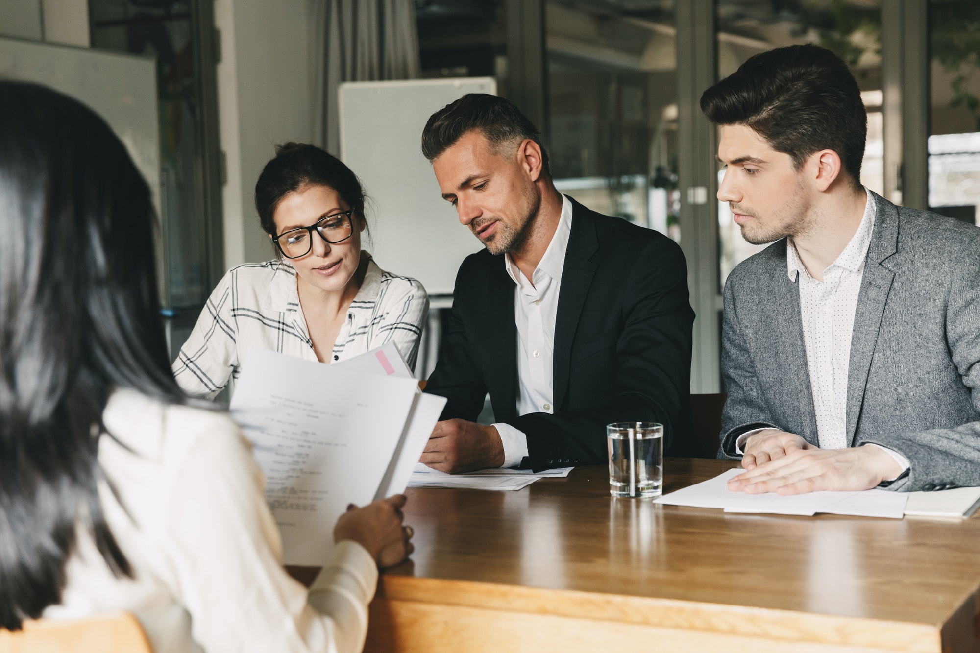 roup of professionals in a modern conference room discussing ideas